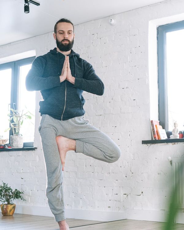 Focused man meditating after a workout session in a calm environment.